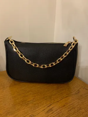 Black leather bag with gold chain strap