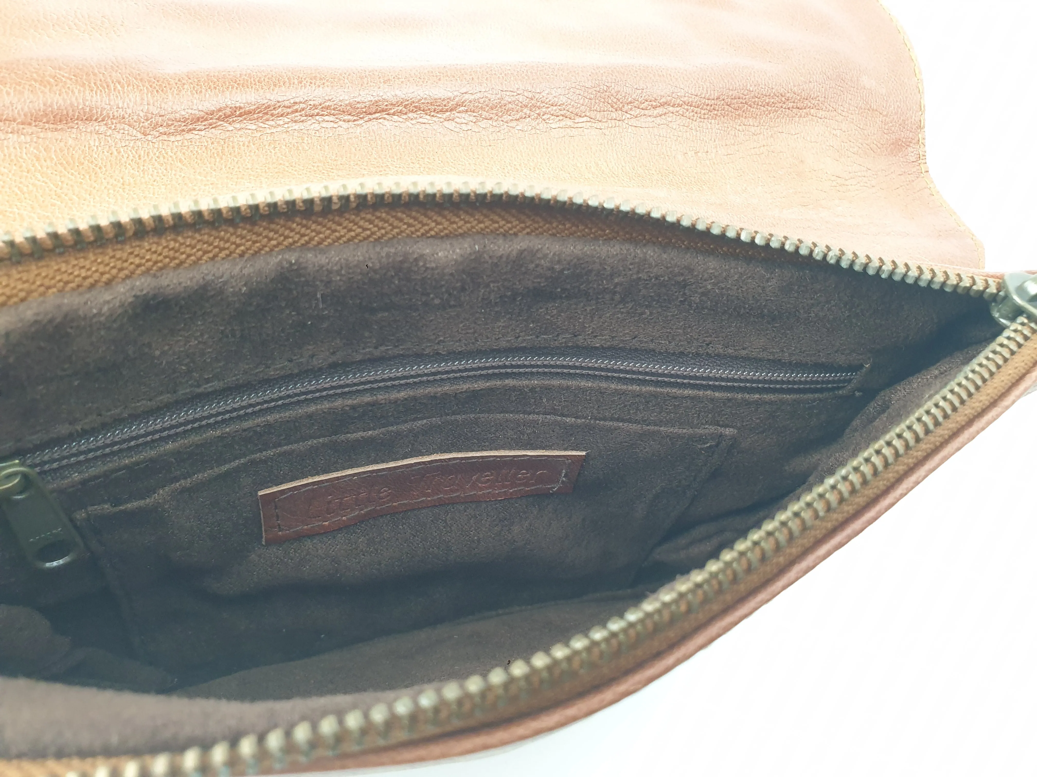 Little Traveller brown leather clutch with front fabric detail