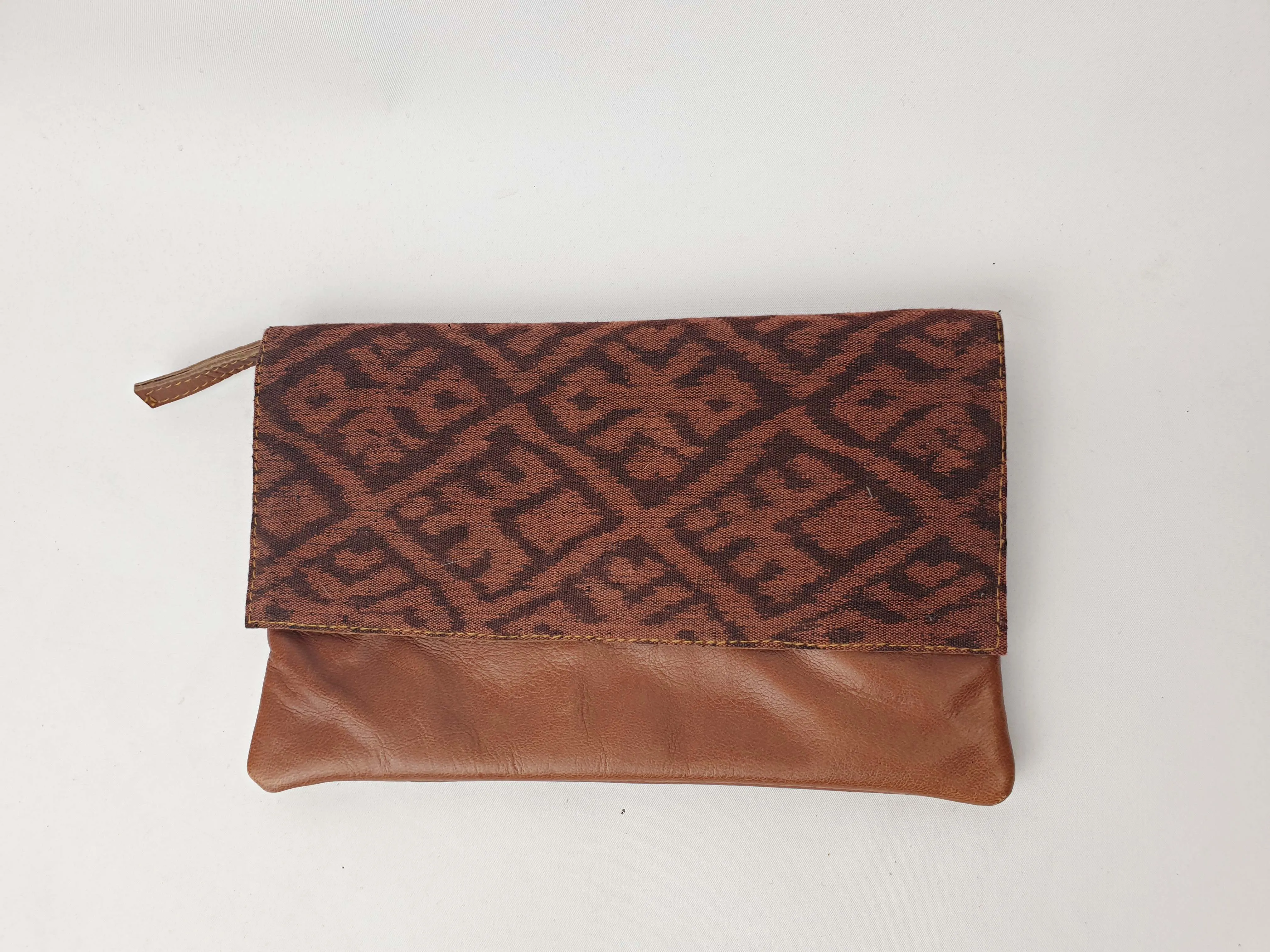 Little Traveller brown leather clutch with front fabric detail