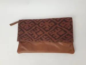 Little Traveller brown leather clutch with front fabric detail